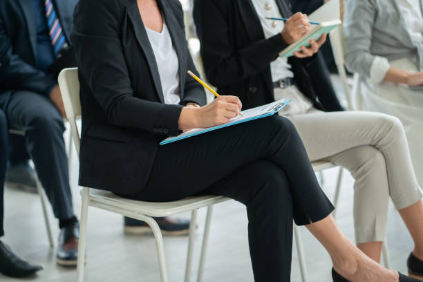istock close up businesswoman concentrate in workshop training with writing on notebook at seminar hall, Business workshop training event. Business workshop training concepts. 1331069343
