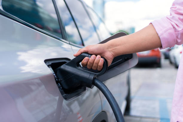 istock Man Charging Electric Car 1331069626