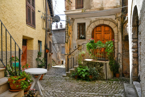 The old town of Maenza in Lazio region. Maenza, Italy, 07/24/2021. A small street between the old stone houses of a medieval village in the province of Latina. medieval architecture stock pictures, royalty-free photos & images