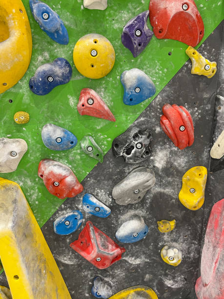 istock VERTICAL: Towering black and green artificial climbing wall is filled with holds 1331071342