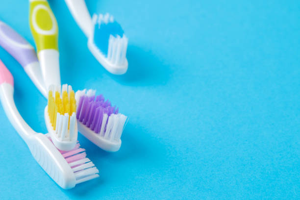 istock Oral hygiene. Multi-colored toothbrush on a bright blue background. place for text. 1331071384