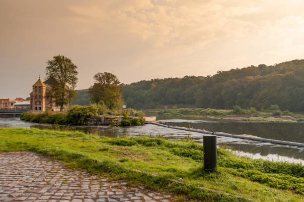 River Mulde near Grimma in Saxony River Mulde near Grimma in Saxony with building "Grossmuehle", german for large mill, in background in evening light grimma stock pictures, royalty-free photos & images