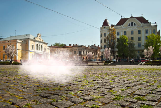 istock Cobblestone close-up. Sharpness on granite tile. Square and street are blurred in the background. Layout for design. A white cloud flies over the pavement. 1331072148
