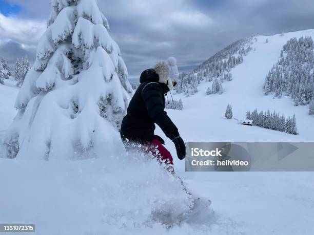 Close Up Young Woman Shreds Fresh Powder While Snowboarding In Backcountry Stock Photo - Download Image Now