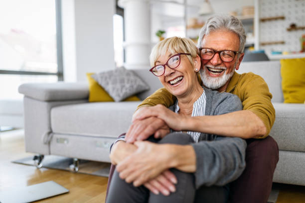 Happy senior couple in love hugging and bonding with true emotions Happy senior couple in love hugging and bonding with true emotions at home active seniors stock pictures, royalty-free photos & images