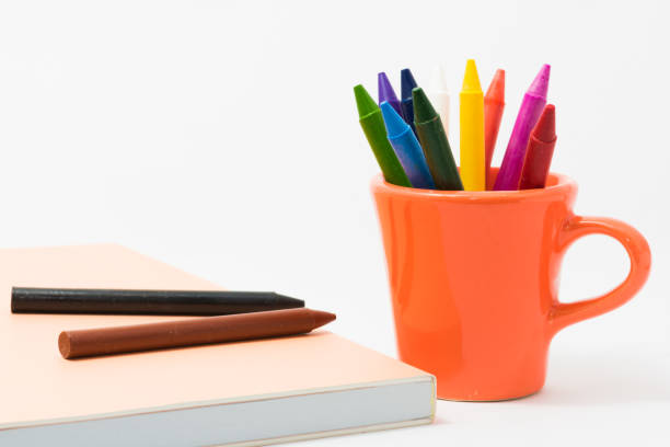 crayons full color with small cup and a book for the child