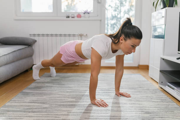 istock Strong young woman doing push-ups 1331072998