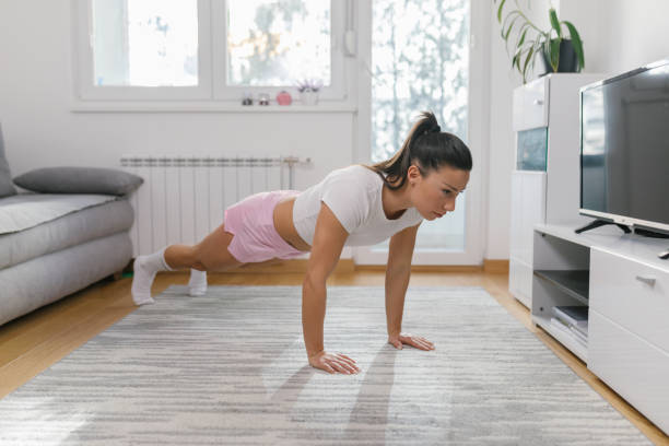 istock Beautiful young sporty lady doing push ups 1331073041