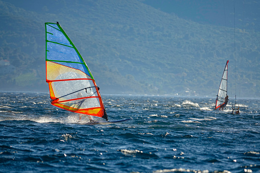 COPY SPACE: Windsurfers explore the picturesque Adriatic sea near the Peljesac peninsula on a sunny summer day. Scenic shot of kitesurfers enjoying the winds and surfing waves in the Mediterranean.