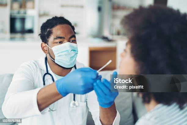 Doctor Testing A Woman For Covid19 Virus Stock Photo - Download Image Now - Coronavirus, Medical Test, Medical Exam