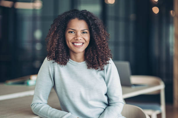 istock Smiling young woman in the office 1331075792