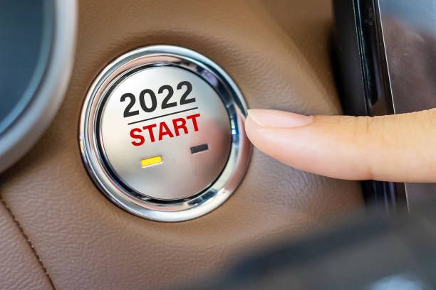 istock Finger press a car ignition button with 2022 START text inside modern electric automobile. New Year New You, resolution, change, goal, vision, innovation and planning concept 1331075965