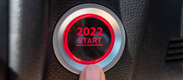istock Finger press a car ignition button with 2022 START text inside modern electric automobile. New Year New You, resolution, change, goal, vision, innovation and planning concept 1331076598