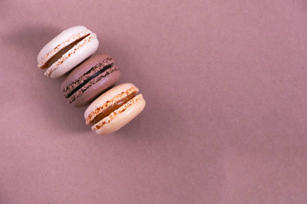 istock macarons on a paper background, brown and beige background, pastel colors 1331076708