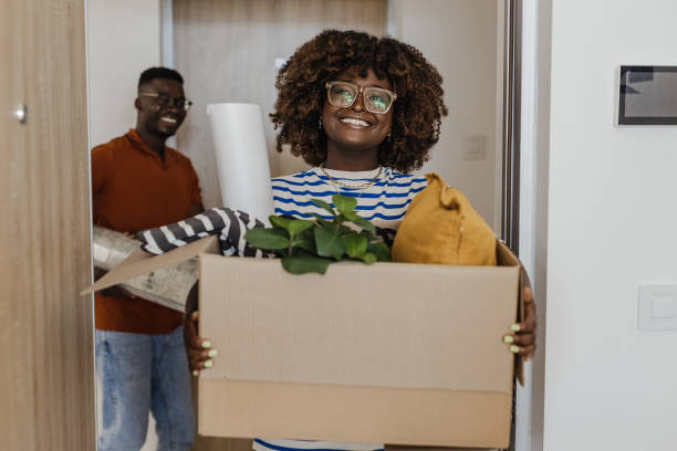 istock Couple carrying boxes into new apartment 1331077606