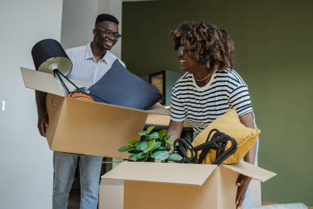 istock Couple carrying boxes into new apartment 1331078294