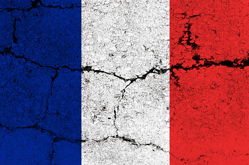 French Flag on cracked wall background.