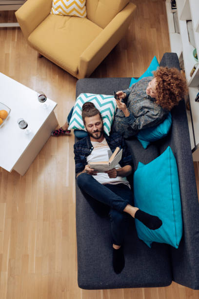 istock Young couple relaxing on the sofa together 1331081510