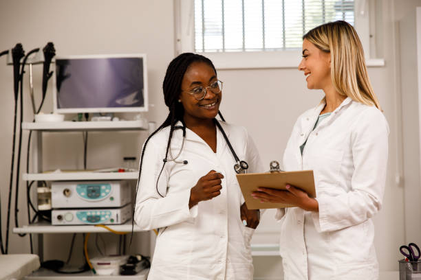 istock Two cheerful young female doctors smiling at each other while discussing medicine 1331083013