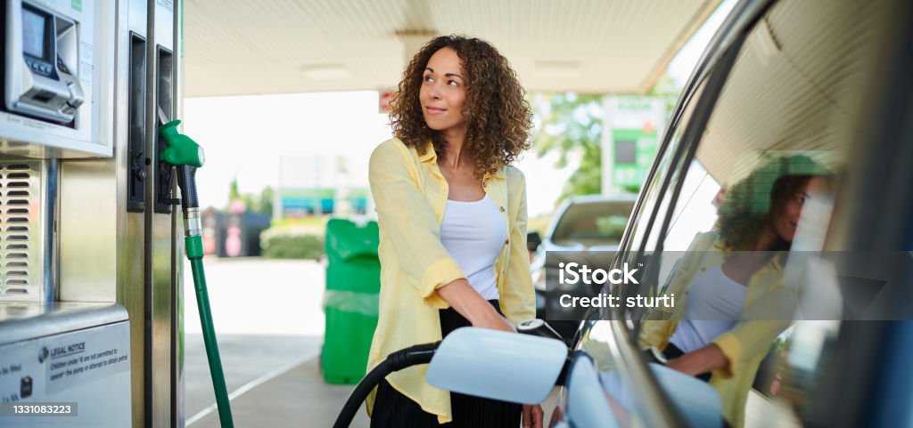 woman filling up at the petrol pump Fuel Pump Stock Photo