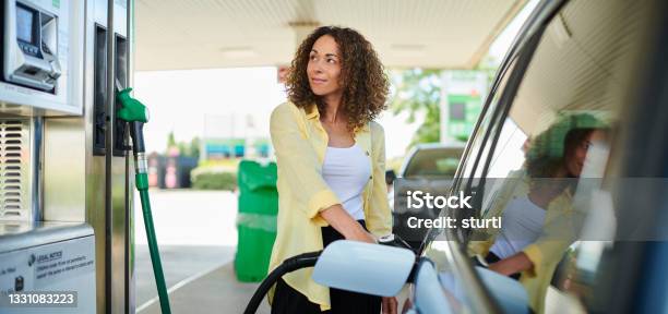 Woman Filling Up At The Petrol Pump Stock Photo - Download Image Now - Fuel Pump, Gas Station, Refueling