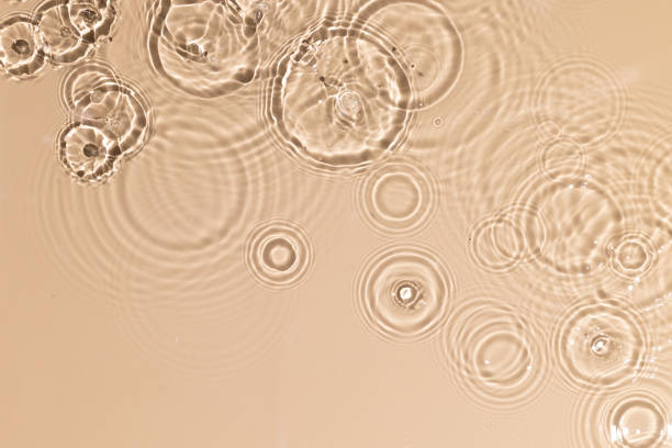 istock Beige water texture with ripples and transparent at sunlight. Backdrop for cosmetic or spa concept background. Copy space 1331083428