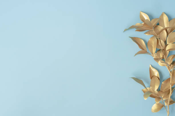istock golden leaves on blue pastel background 1331084757