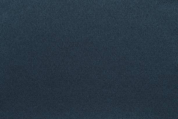 濃い青色のテクスチャー状の粒状ファブリックの背景 ストックフォト