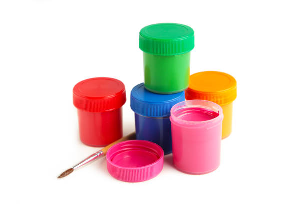 istock Multicolored jars of gouache and a brush isolated on white background. Creative kit. 1331086921