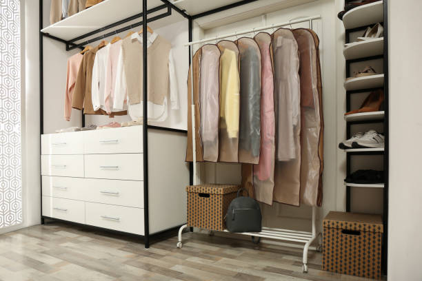 istock Garment bags with clothes on rack in dressing room 1331089104