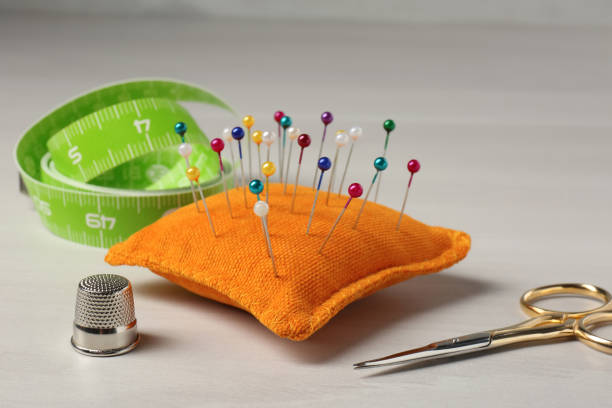 Set of sewing supplies and accessories on white table