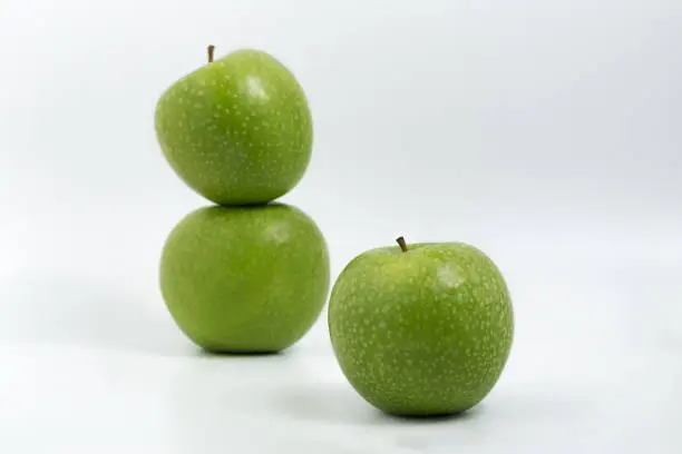 green apple on white background in Valencia, Valencian Community, Spain