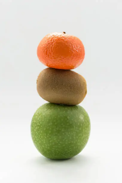 tangerine, kiwi and apple on white background in Valencia, Valencian Community, Spain