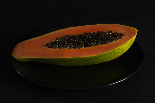 Slice of tasty papaya isolated on white. Flat lay. Top view. Tropical fruit concept