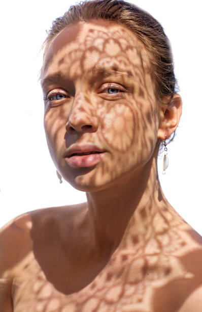 istock Headshot of a female face behind summer shadow 1331092394