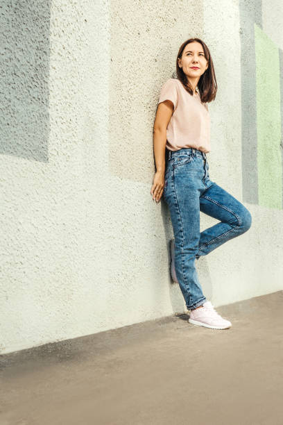 istock Attractive young woman posing against concrete wall. 1331092860