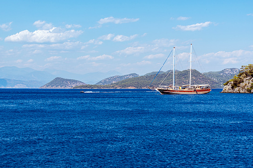 Wooden sailing boat moored on the beach in Gocek bay of Fethiye, Turkey.