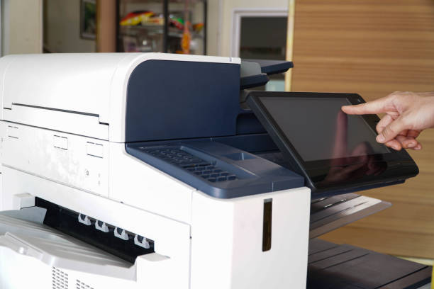 istock Business man Hand press button on panel of printer, printer scanner laser office copy machine supplies start 1331099076