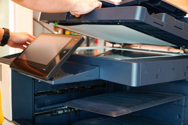 istock Business man Hand press button on panel of printer, printer scanner laser office copy machine supplies start 1331099083