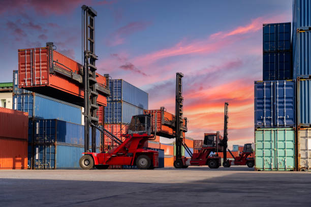 Engineers are overseeing the transportation of cargo with containers inside the warehouse. Container in export and import business and logistics.