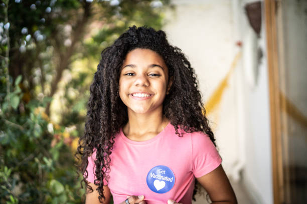 istock Girl showing 'Got Vaccinated' sticker on her shirt 1331100782