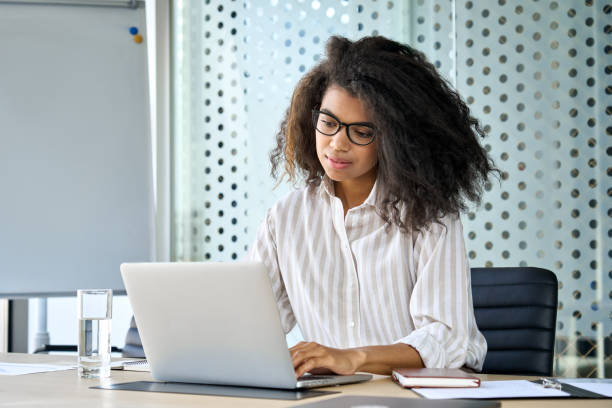 istock Young African American business woman using laptop computer in office. 1331101153