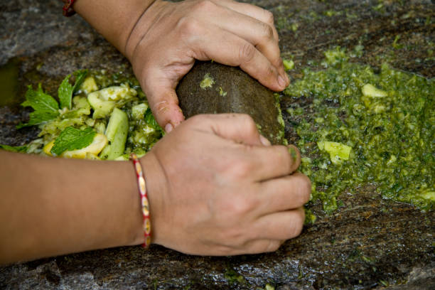 istock Woman hands grinding herbs and spices on stone grinder 1331103641
