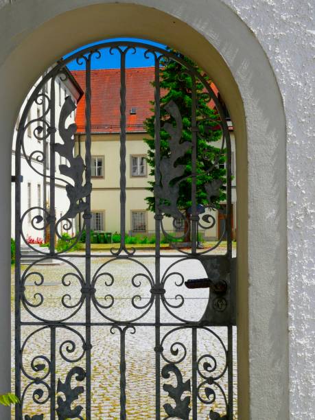 Wrought-iron gate with a view at a monastery in Bavaria