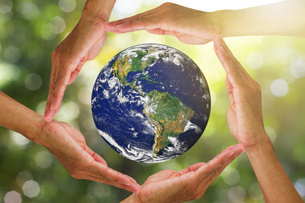 istock Hands holding planet earth on blurred green nature with sunlight background, elements of this image furnished by NASA, environmental concept 1331106115