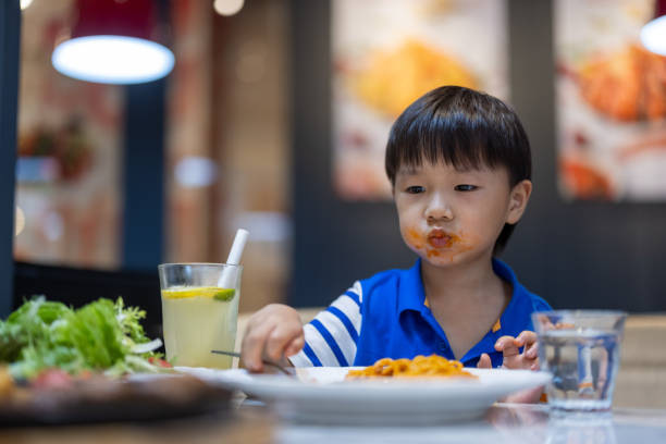 istock A little boy eating in a restaurant 1331107563
