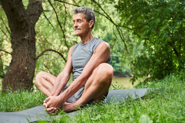 istock Mature man making stretching exercises at the nature at the open air 1331109148