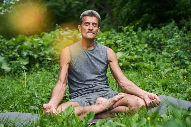 istock Senior man meditating in nature around the trees 1331109246