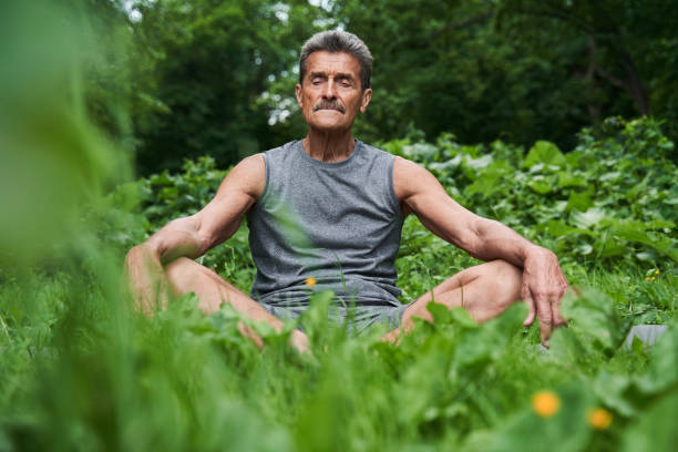 istock Senior man meditating in nature around the trees 1331109259