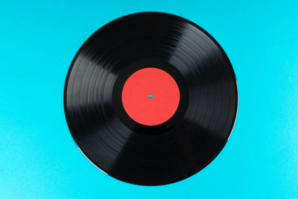 istock Old vinyl disc on blue background. Old vintage vinyl record. 1331111845